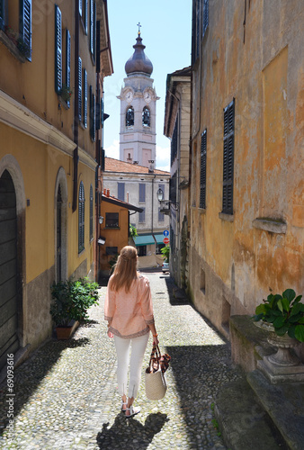 Girl on the cobbled street of Menaggio town. Lake Como, Italy