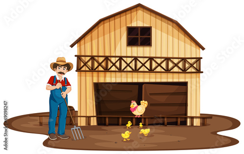 A man standing in front of the wooden barnhouse