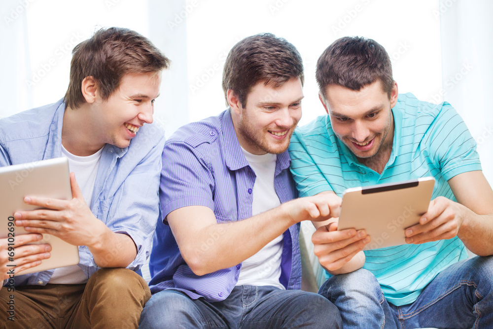 smiling friends with tablet pc computers at home smiling friends with tablet pc computers at home