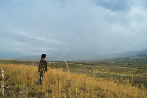 lonely person standing in the fields in a fog © gerda1201