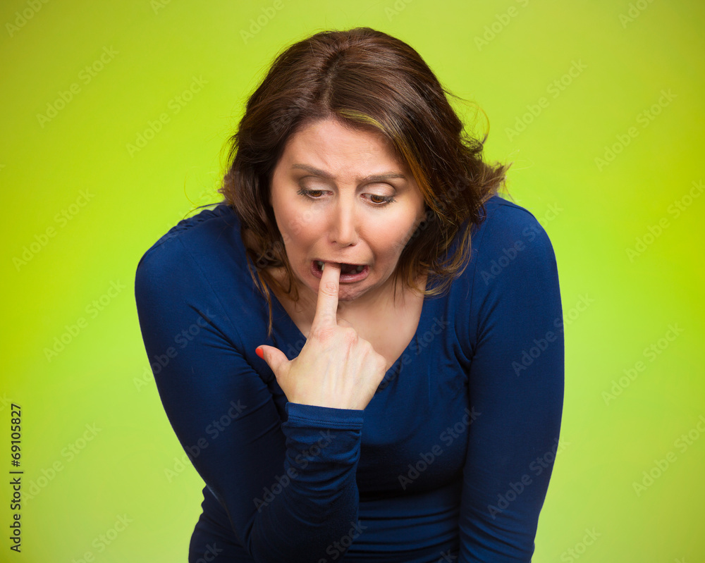 Sick woman sticking finger in throat vomiting, green background Sick woman sticking finger in throat vomiting, green background