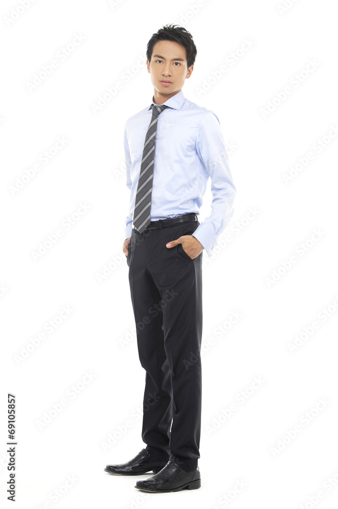 young business man standing with hands in pocket young business man standing with hands in pocket