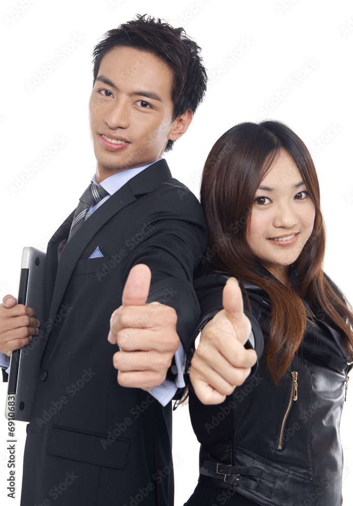 young couple business people holding their thumbs up young couple business people holding their thumbs up