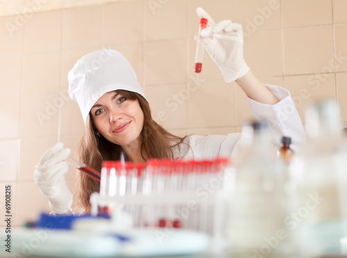 Positive  nurse with test tubes photo