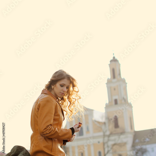 Beautiful girl praying on the background of the church