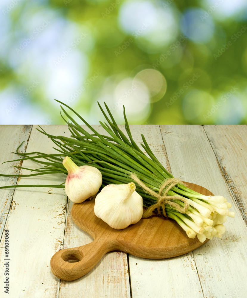 image of green onions and garlic on the board image of green onions and garlic on the board