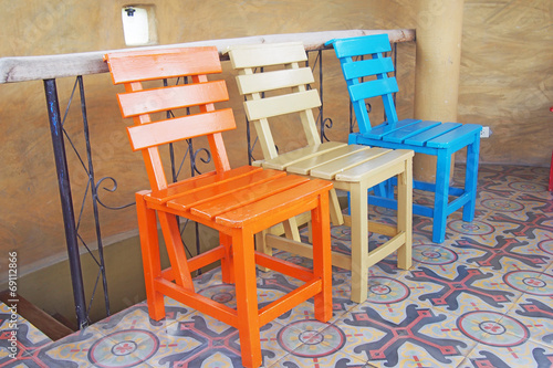 wooden chairs on ceramic tiles floor