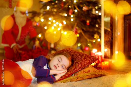 Little girl sleeping under the Christmas tree © MNStudio
