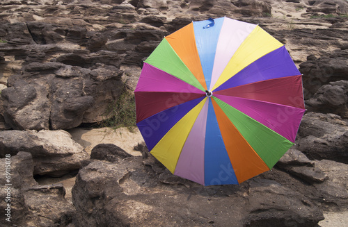 colorful umbrella on rock © khwanchai