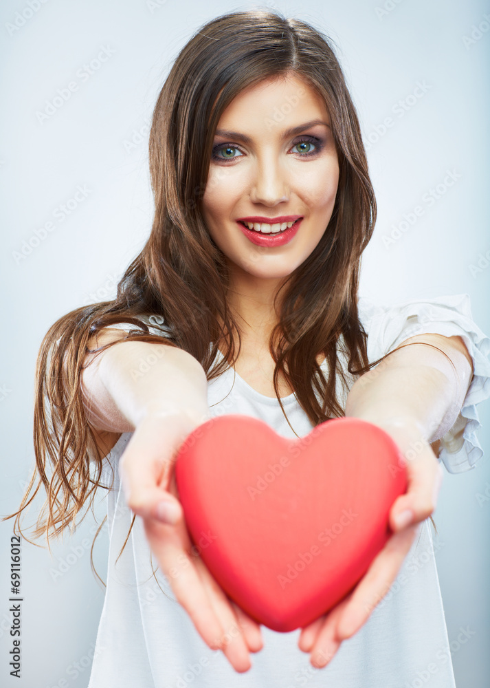 Red heart. Love symbol. Portrait of beautiful woman hold Valent Red heart. Love symbol. Portrait of beautiful woman hold Valent