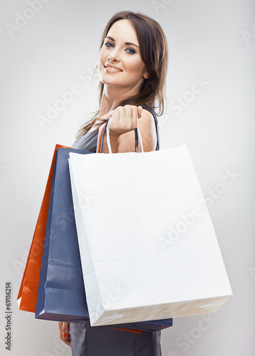 Portrait of young woman, shopping bag. Isolated studio backgrou