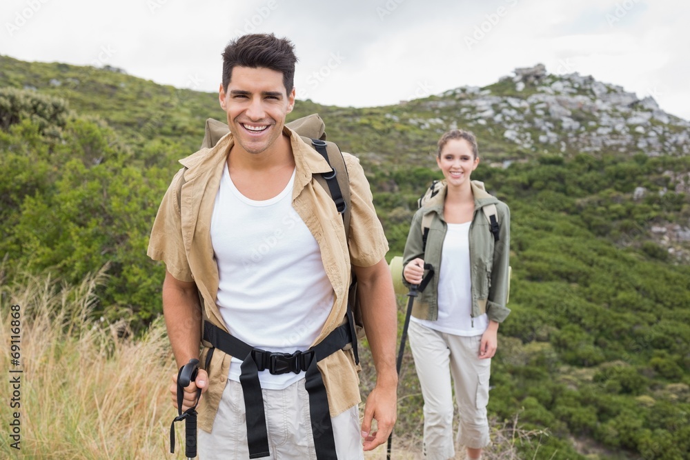 Couple walking on mountain terrain