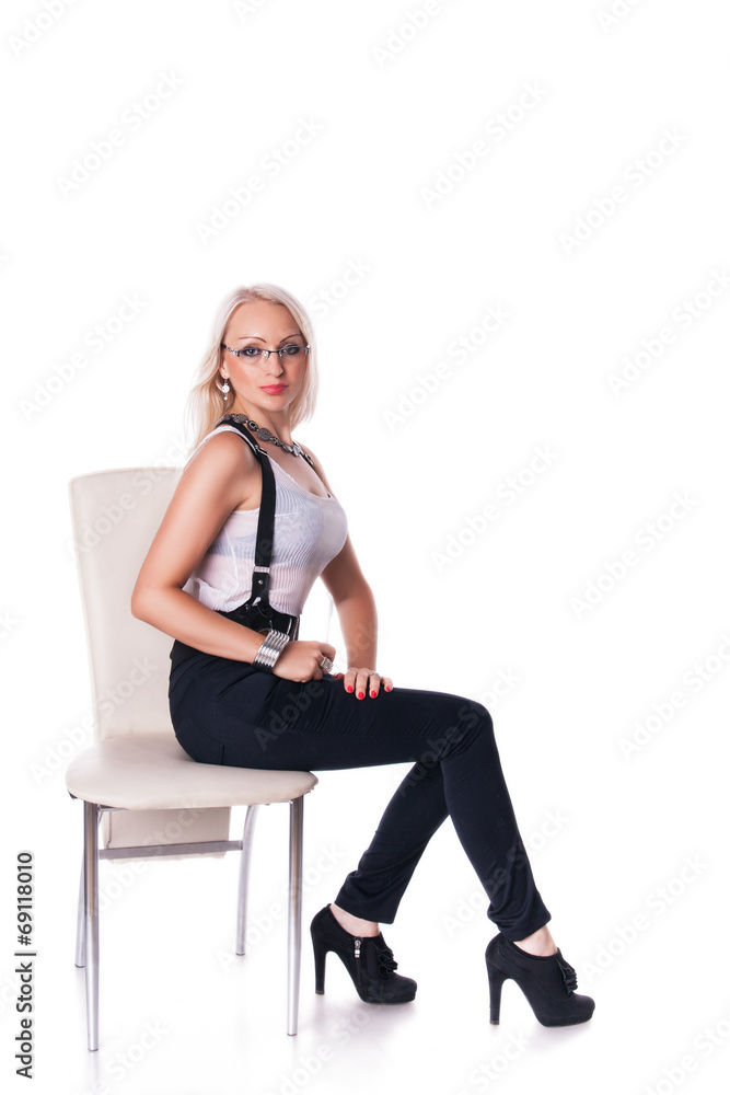 Businesswoman stands near a chair Businesswoman stands near a chair