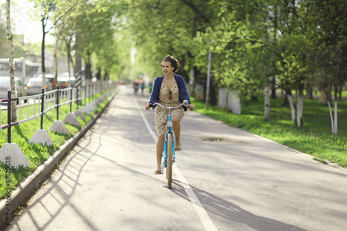 girl in a dress on a bicycle