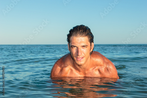 Portrait of a handsome young muscular man in swimwear © Netfalls