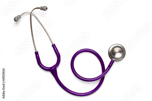 Old purple stethoscope on isolated photo