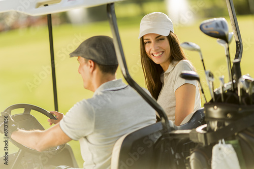Young couple at golf cart