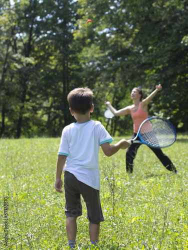 Mother and son playing tennis