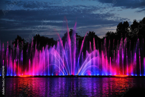 amazing dancing fountain in night illuminated red and blue color