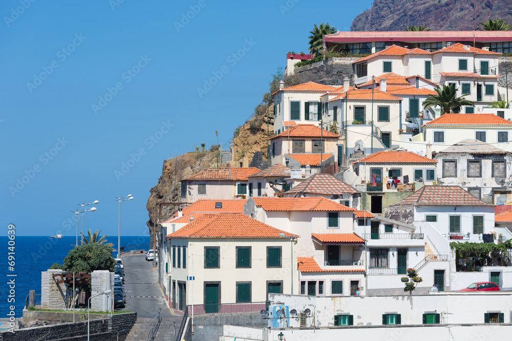 Houses Camara de Lobos against a cliff at Madeira Island