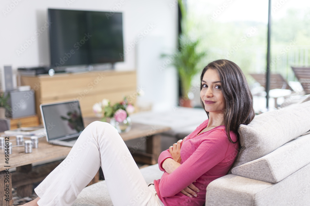 cheerful woman at home resting on a couch cheerful woman at home resting on a couch