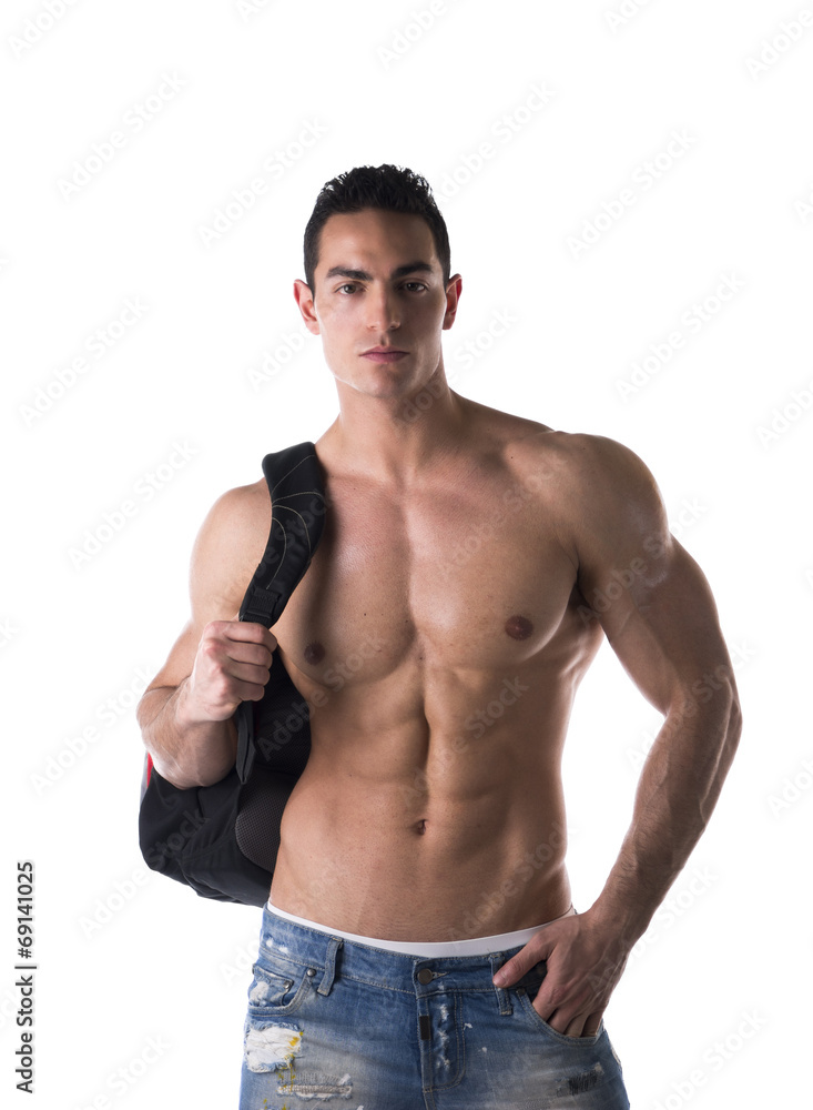 Shirtless muscular young man with backpack on his back Shirtless muscular young man with backpack on his back