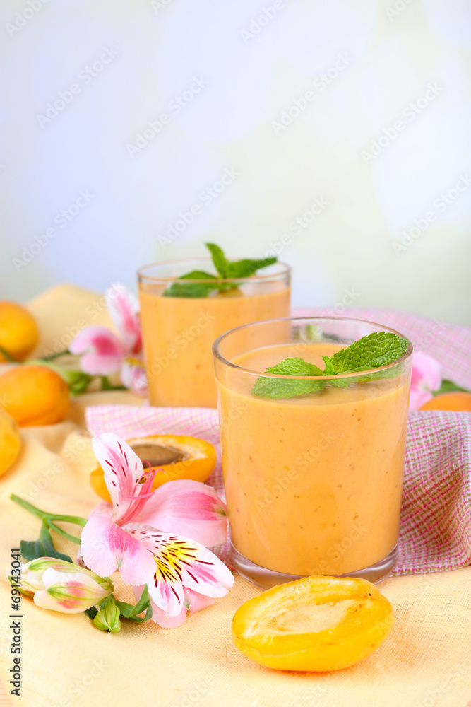 Apricot dessert in glasses on table on bright background Apricot dessert in glasses on table on bright background