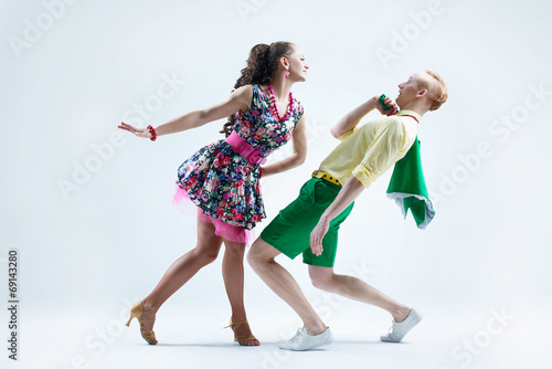 Funny dancer couple dressed in boogie-woogie pin up style