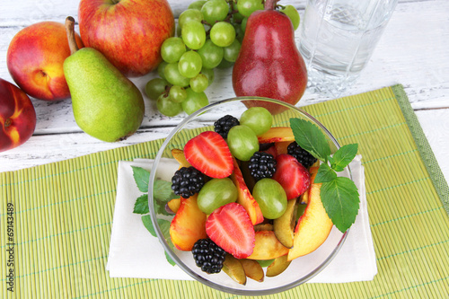 fresh tasty fruit salad on table