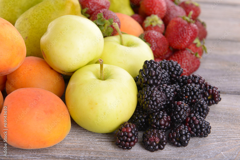Ripe fruits and berries on wooden background Ripe fruits and berries on wooden background