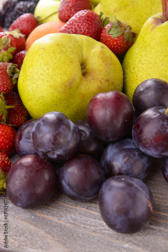 Ripe fruits and strawberries on table close up