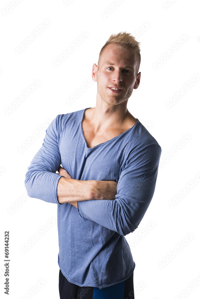 Fit male model posing with confidence, arms crossed on chest Fit male model posing with confidence, arms crossed on chest