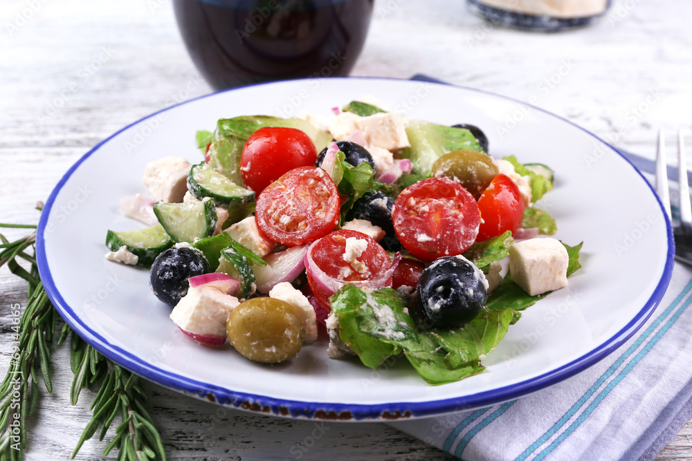 Plate of Greek salad served with wine Plate of Greek salad served with wine