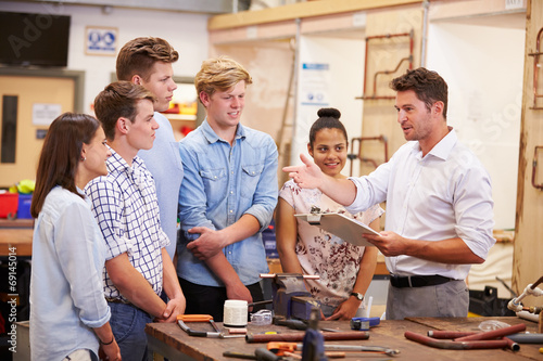 Teacher Helping College Students Studying Plumbing photo