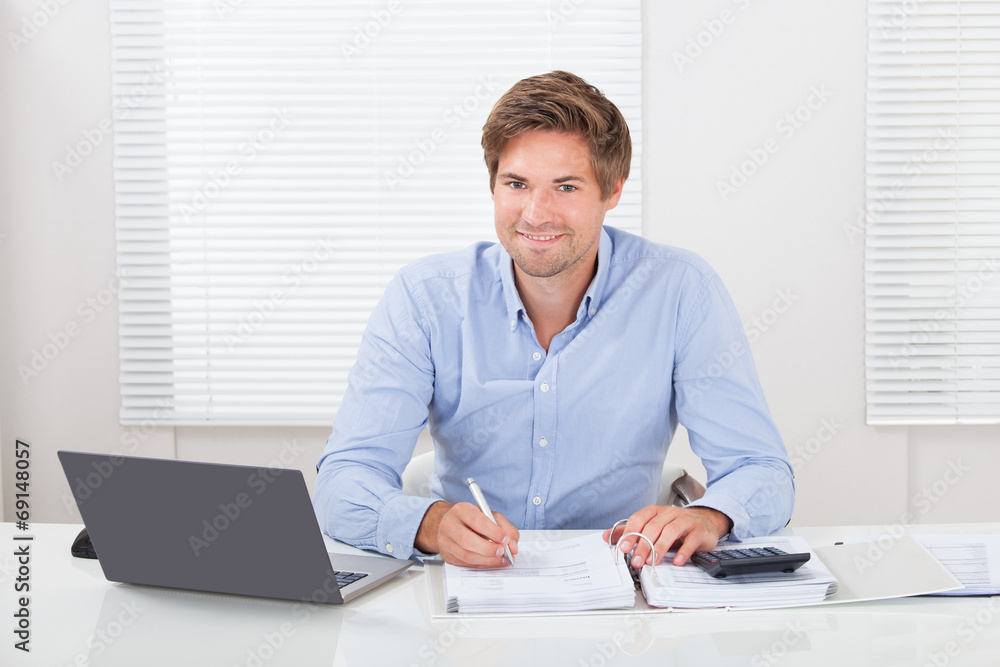 Businessman Working At Desk In Office Businessman Working At Desk In Office