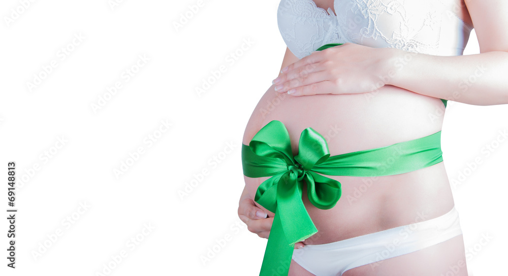 Beautiful young pregnant woman with green ribbon. Isolated on wh