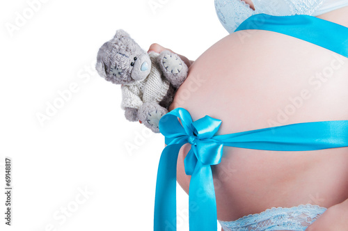 Obraz na płótnie Pregnant belly with blue ribbon w salonie