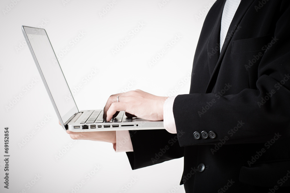 Asian business man using laptop computer isolated on white backg