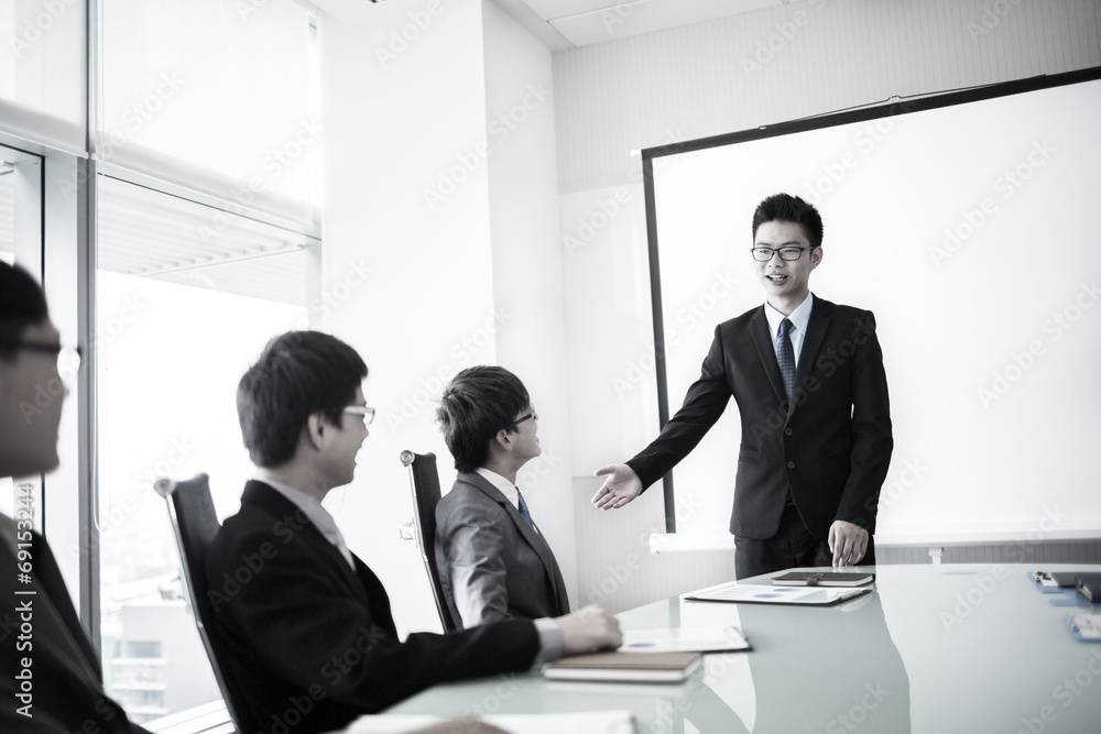 businessman giving a presentation to his colleagues businessman giving a presentation to his colleagues