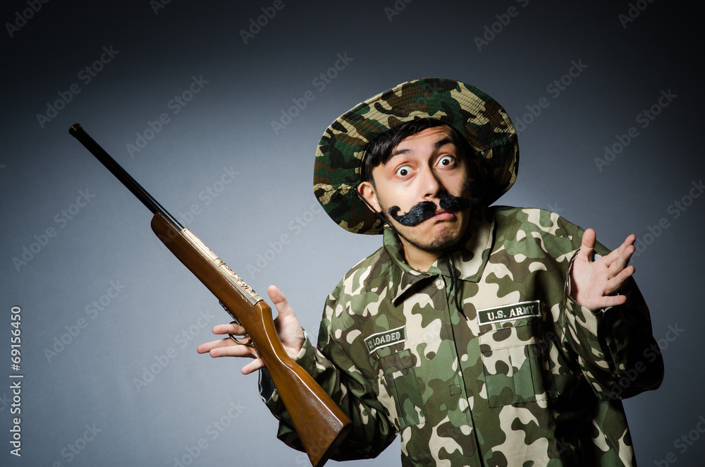 Funny soldier against the dark background Funny soldier against the dark background