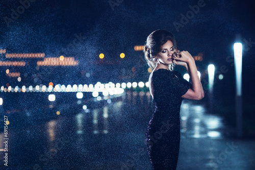 Woman posing in the rain.