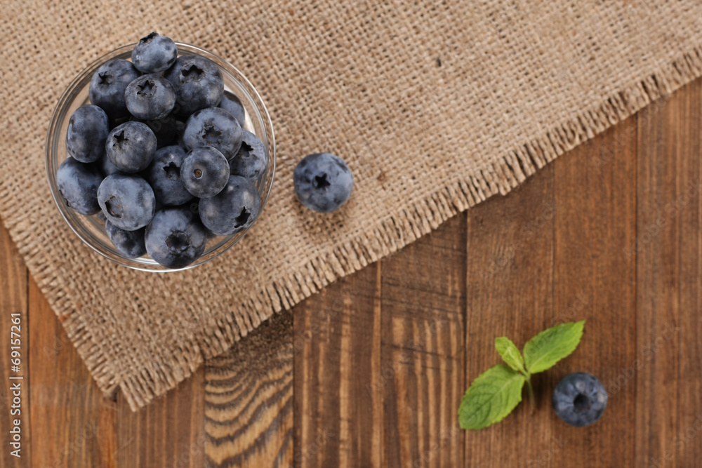 fresh blueberries on a background of burlap planks fresh blueberries on a background of burlap planks