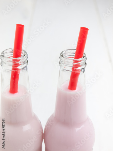 twof pink milkshake with straws photo