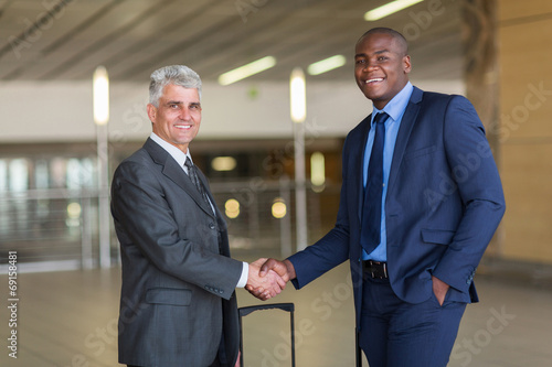 business travellers greeting at airport © michaeljung