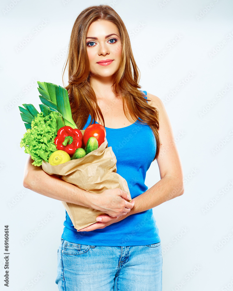 woman hold vegetables in grocery bag woman hold vegetables in grocery bag