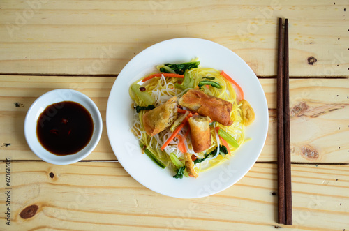 Vietnamese food. Sauteed noodle with crispy spring rolls