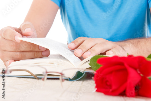 man with his hands holding open book and leafing through pages
