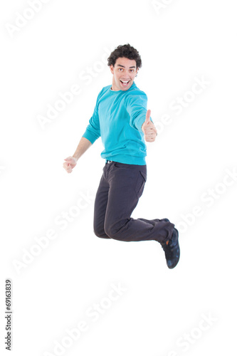 Cheerful young casual man jumping in air showing thumb up