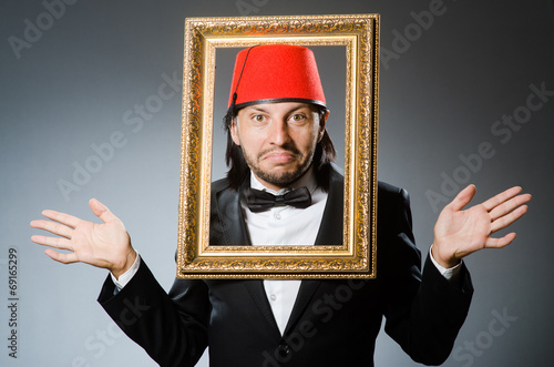 Man with fez hat and picture frame