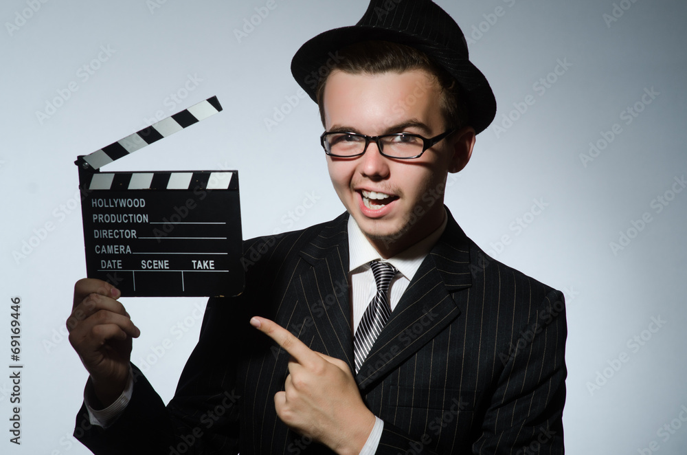 Man with movie clapperboard and hat